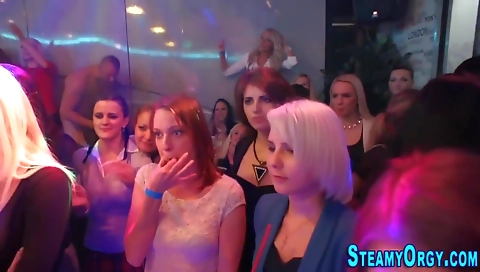 Blonde and black haired woman in a red dress and stockings