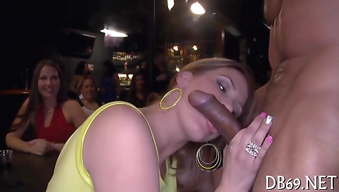 Busty brunette and a group of men suck a big black cock