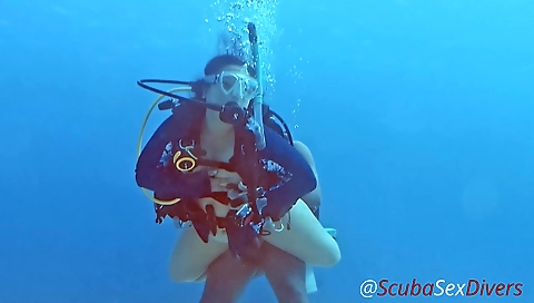 Asian couple having their first scuba sex in the ocean
