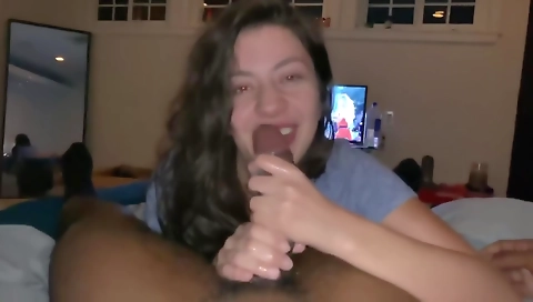 Busty brunette sucks a deepthroat cock in a interracial video