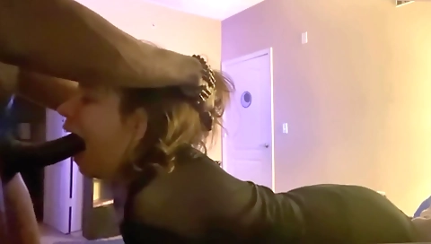 A beautiful brunette with big natural tits sucking a hard cock